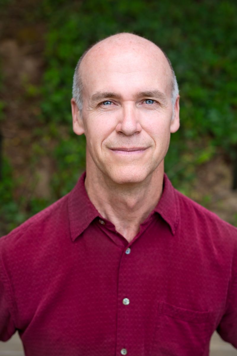 Head shot of Aumkara Newhouse in Cranberry short sleeve shirt